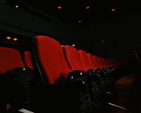 Red seats in a dark theater.