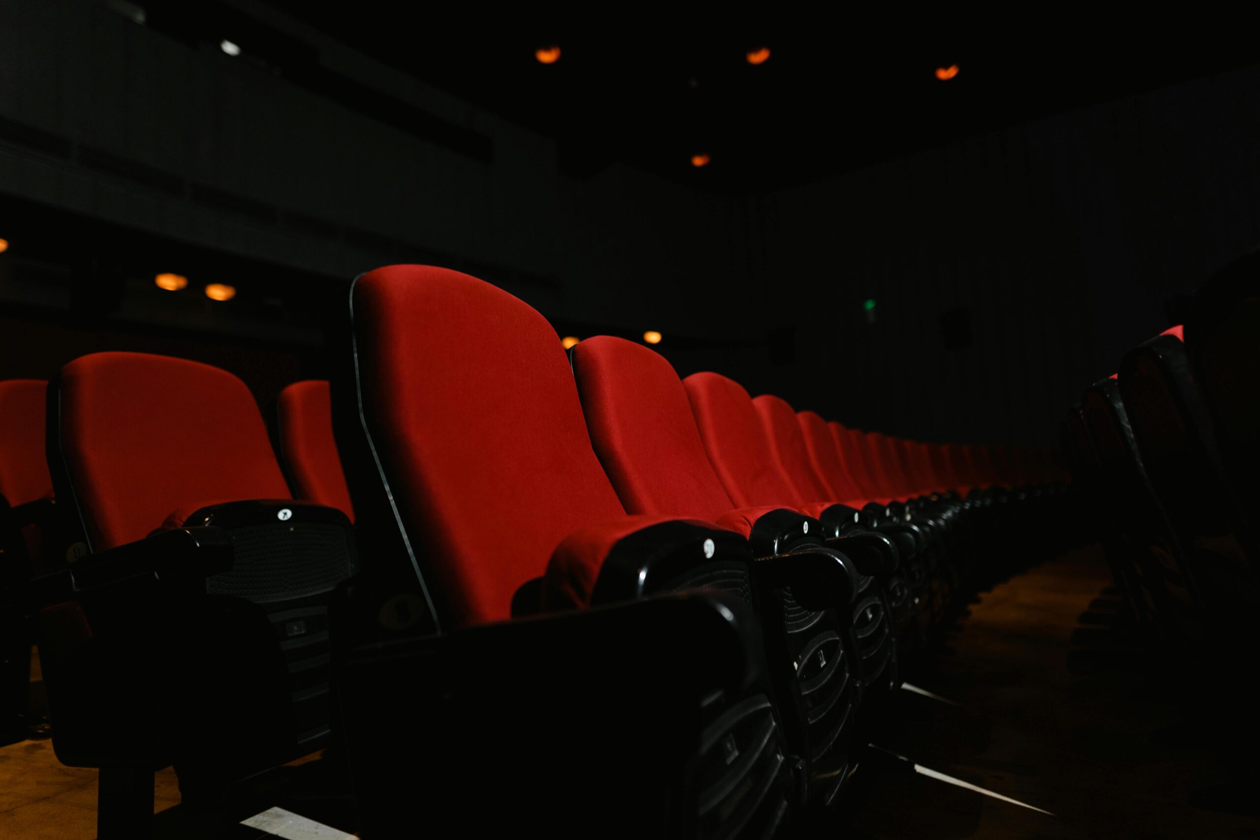 Red seats in a dark theater.