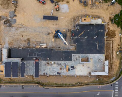 An aerial view of housing development near a road.