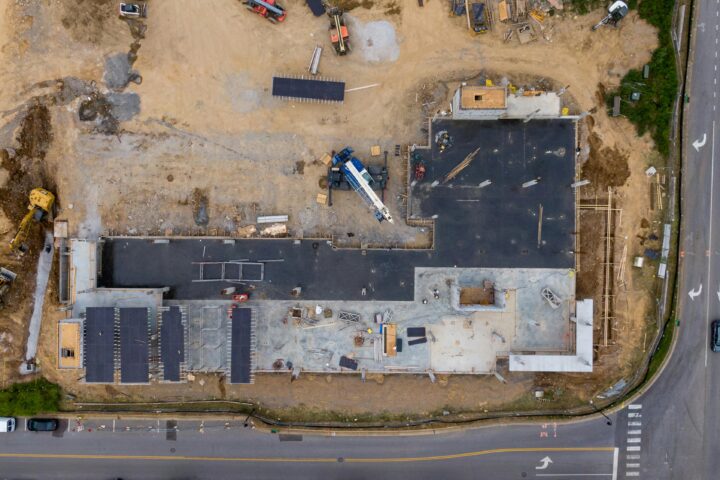 An aerial view of housing development near a road.