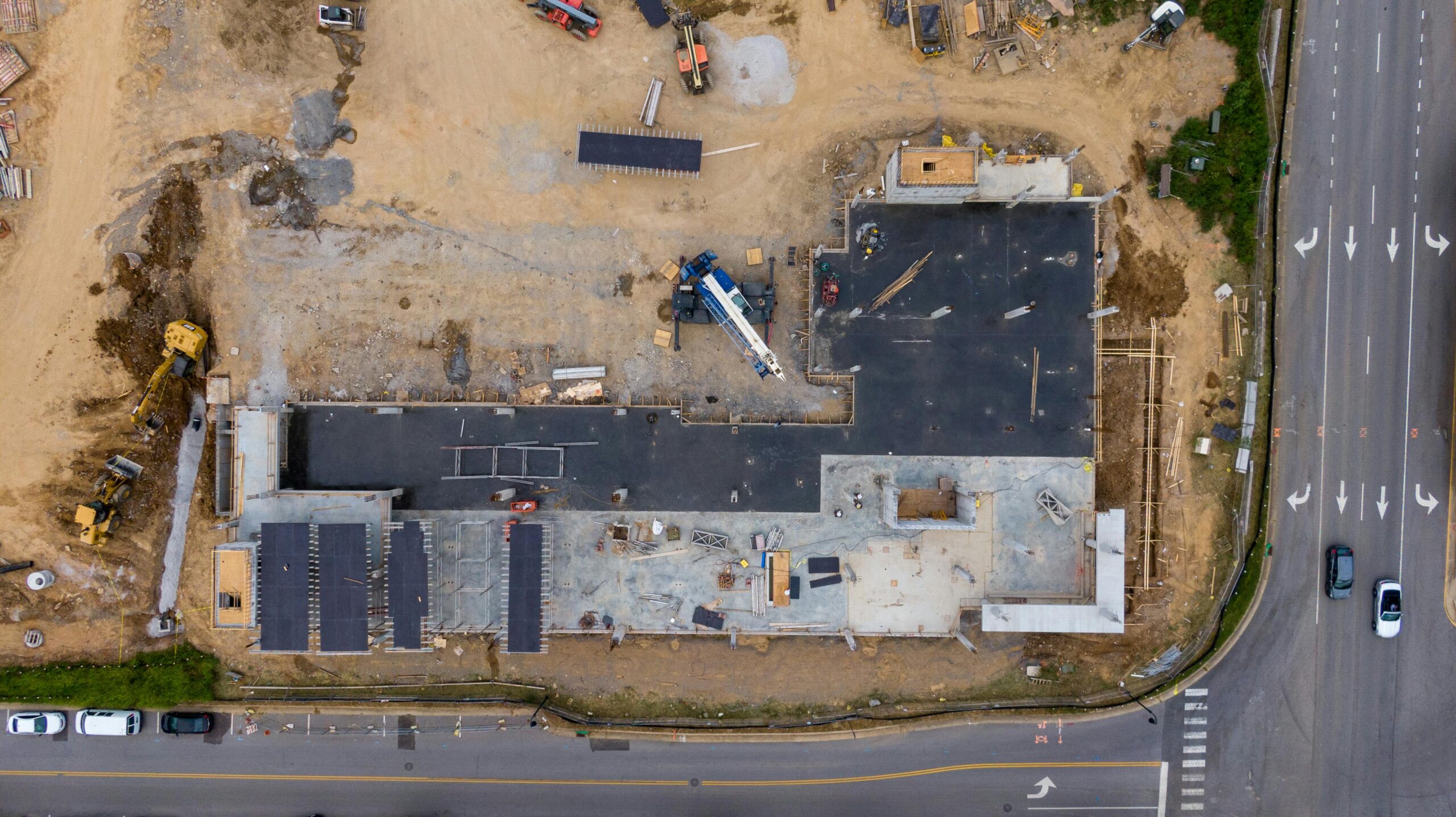 An aerial view of housing development near a road.