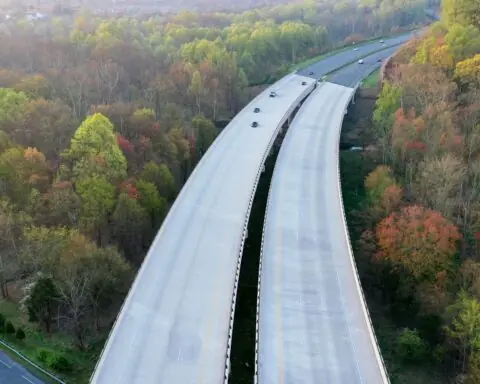 A large highway cuts through trees over another highway in Maryland.