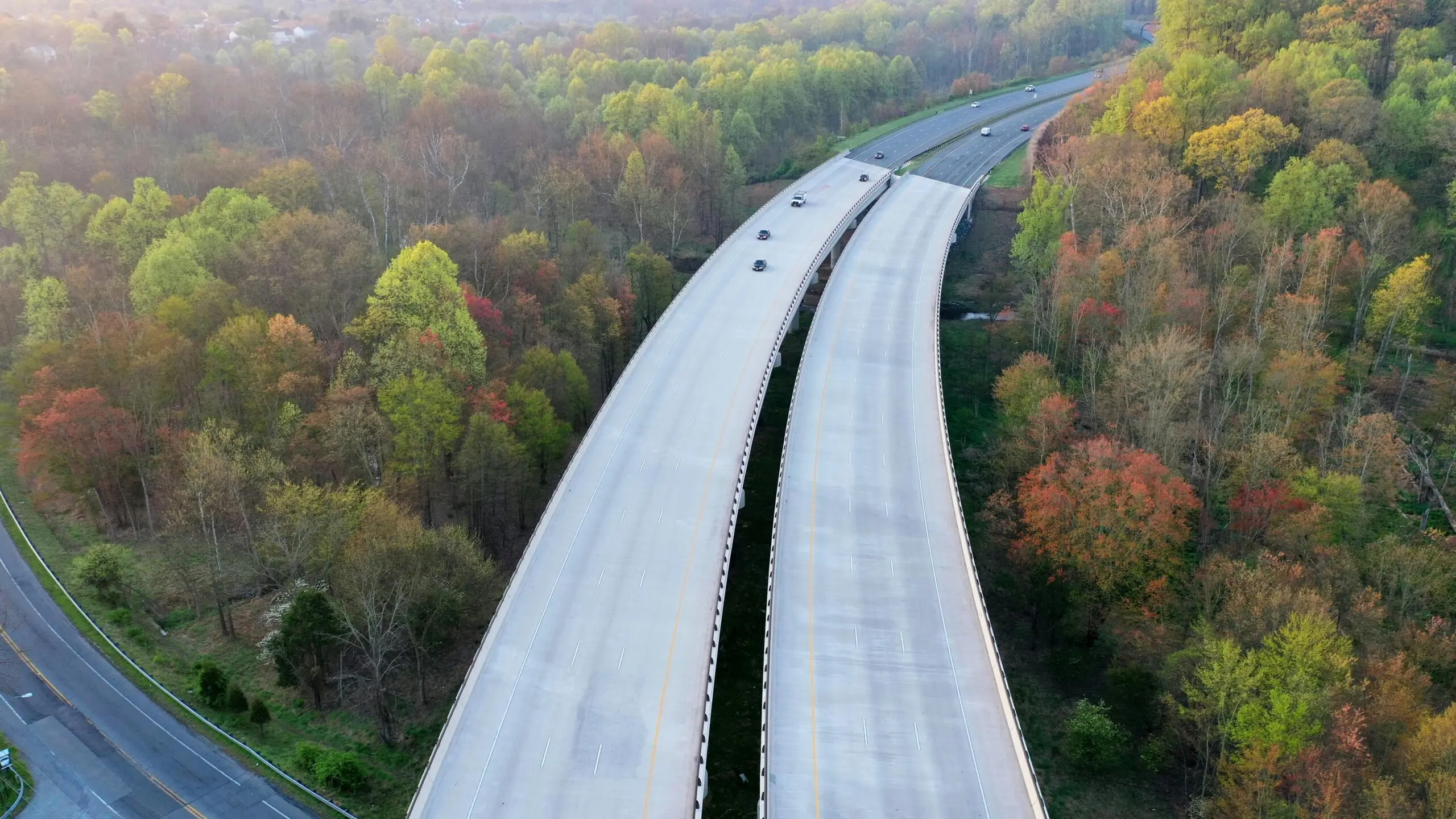 A large highway cuts through trees over another highway in Maryland.