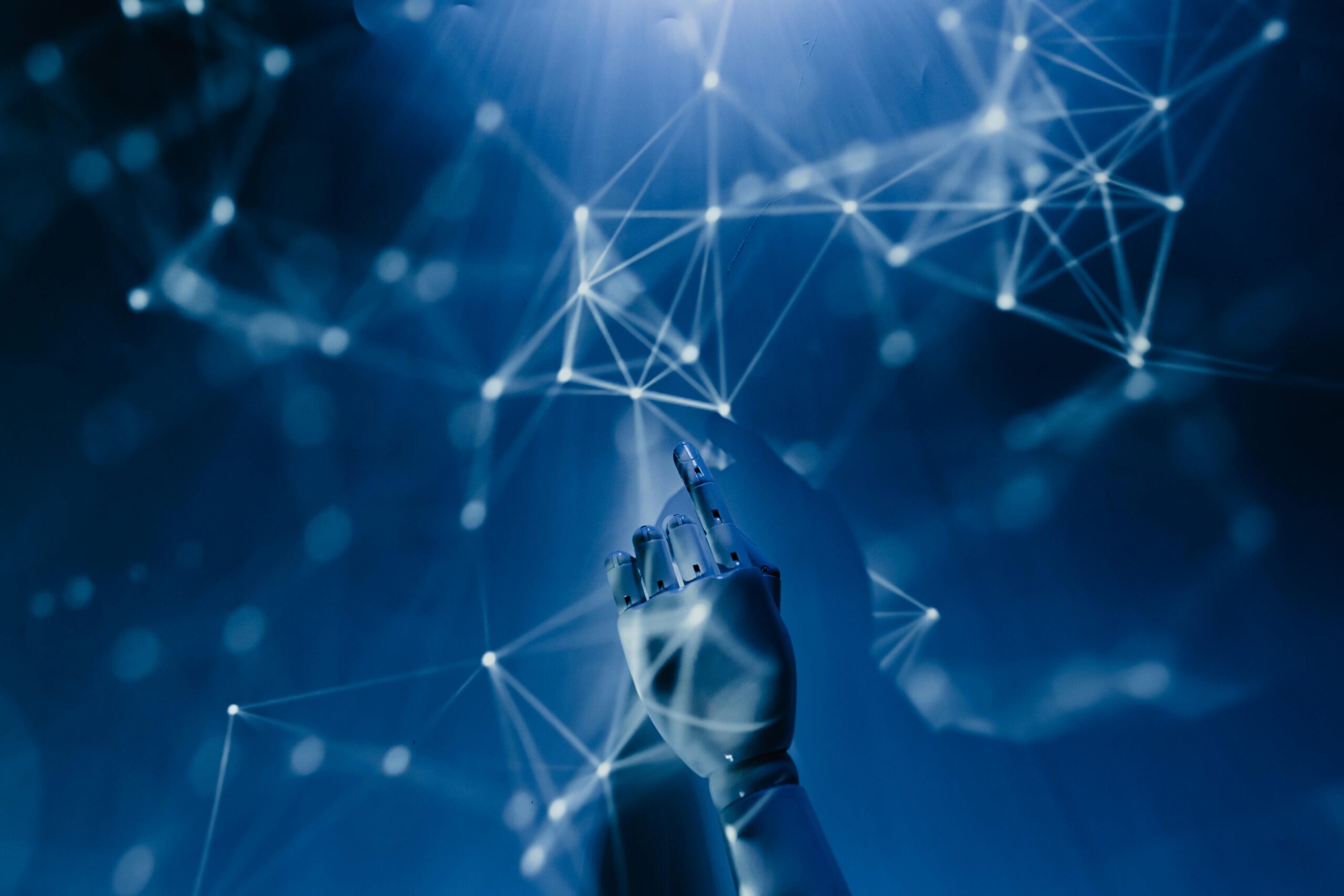 An image depicting a robotic hand reaching for a digitized framework.
