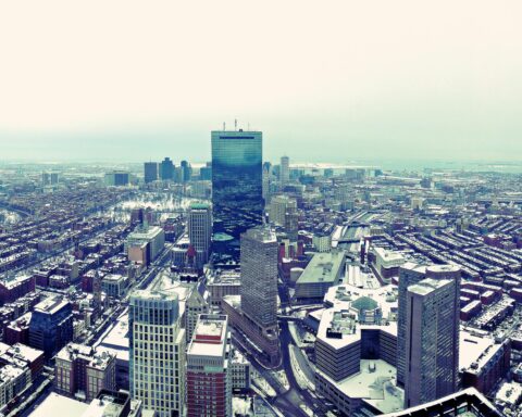 An aerial view of a snow-dusted Boston cityscape.