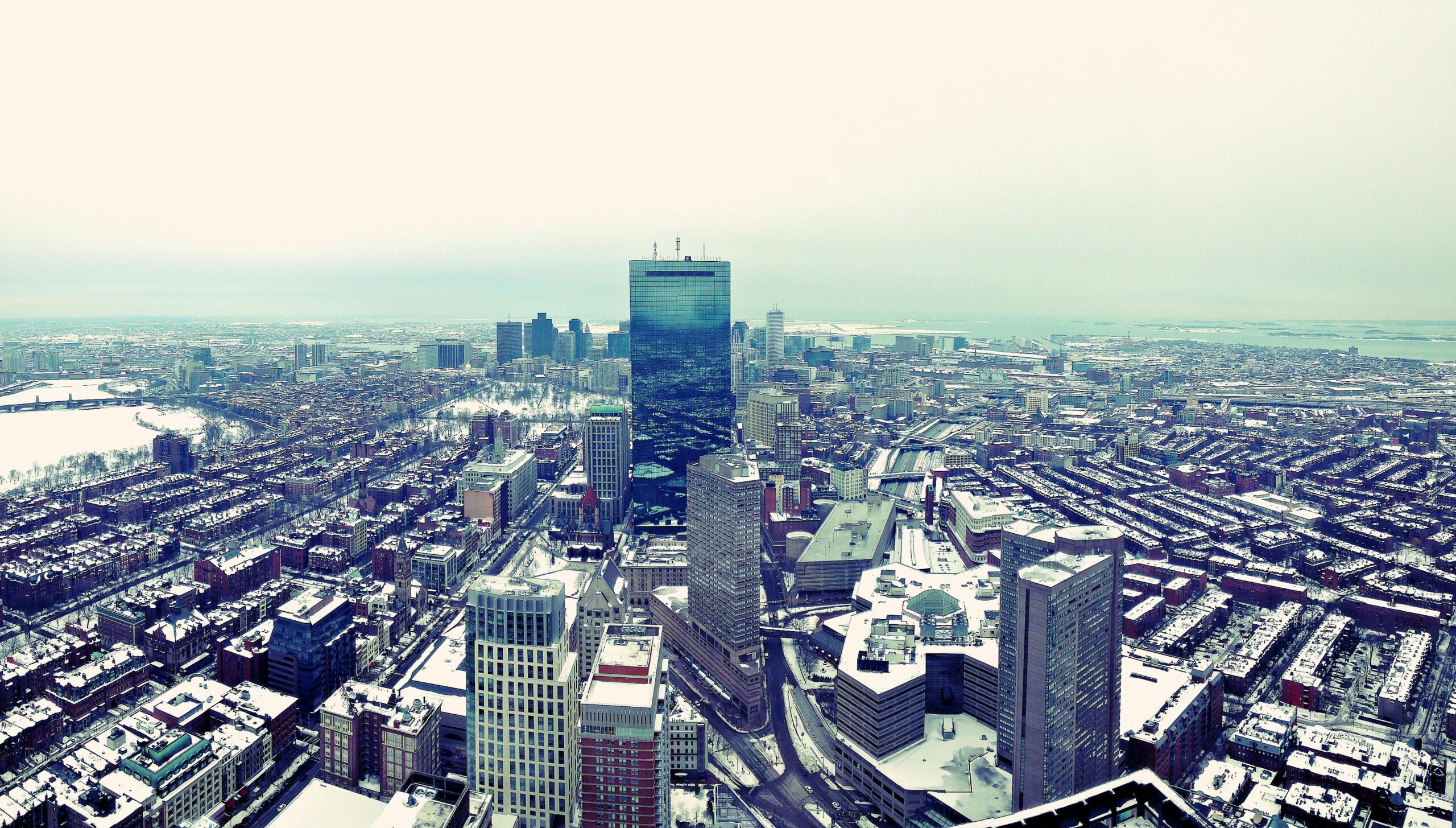 An aerial view of a snow-dusted Boston cityscape.