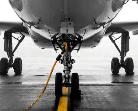 The image depicts an airplane from the front targeting the wheels and undercarriage.