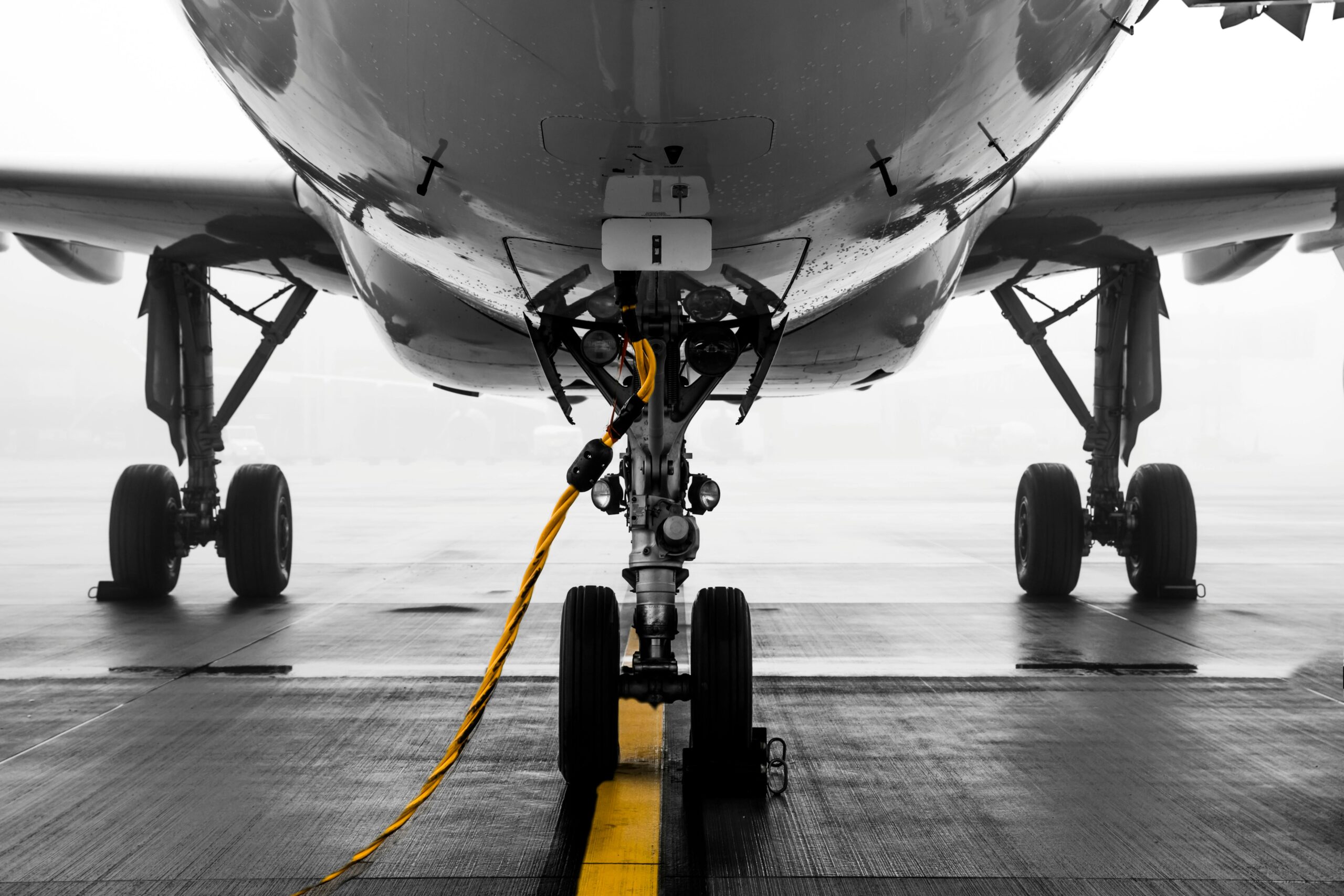 The image depicts an airplane from the front targeting the wheels and undercarriage.