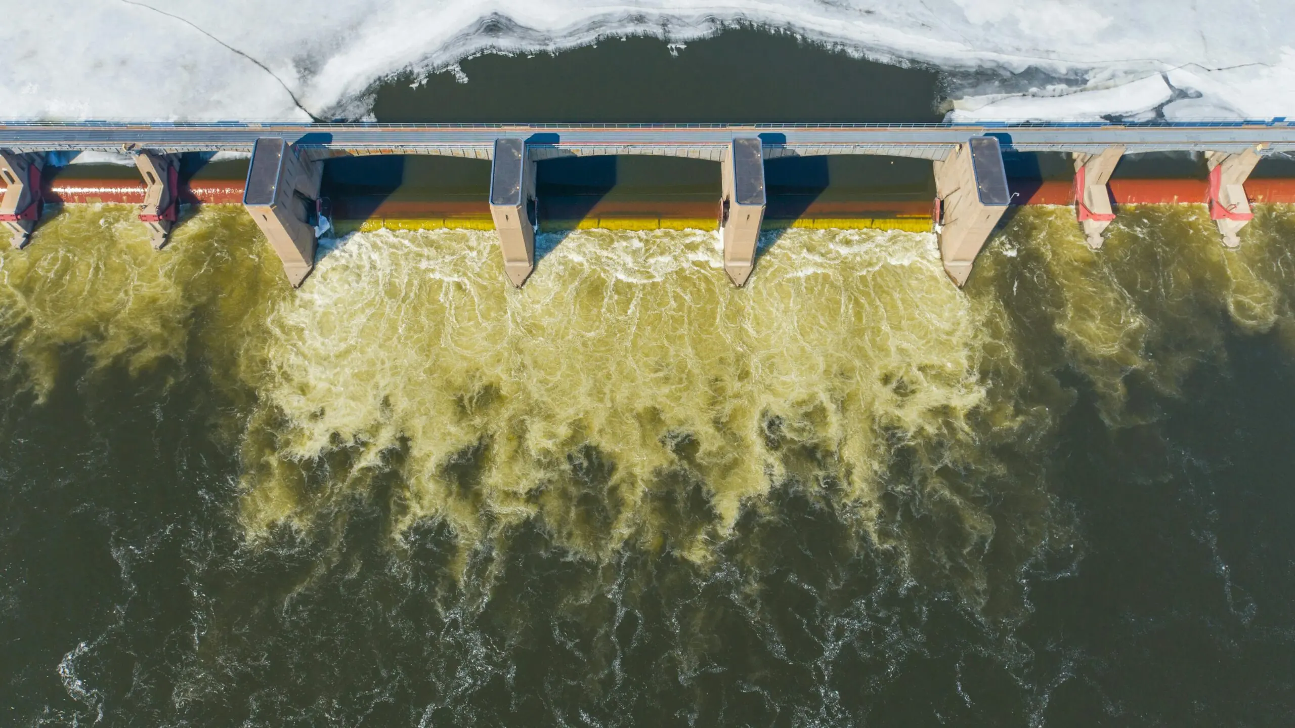 A dam or water break split water along a river.