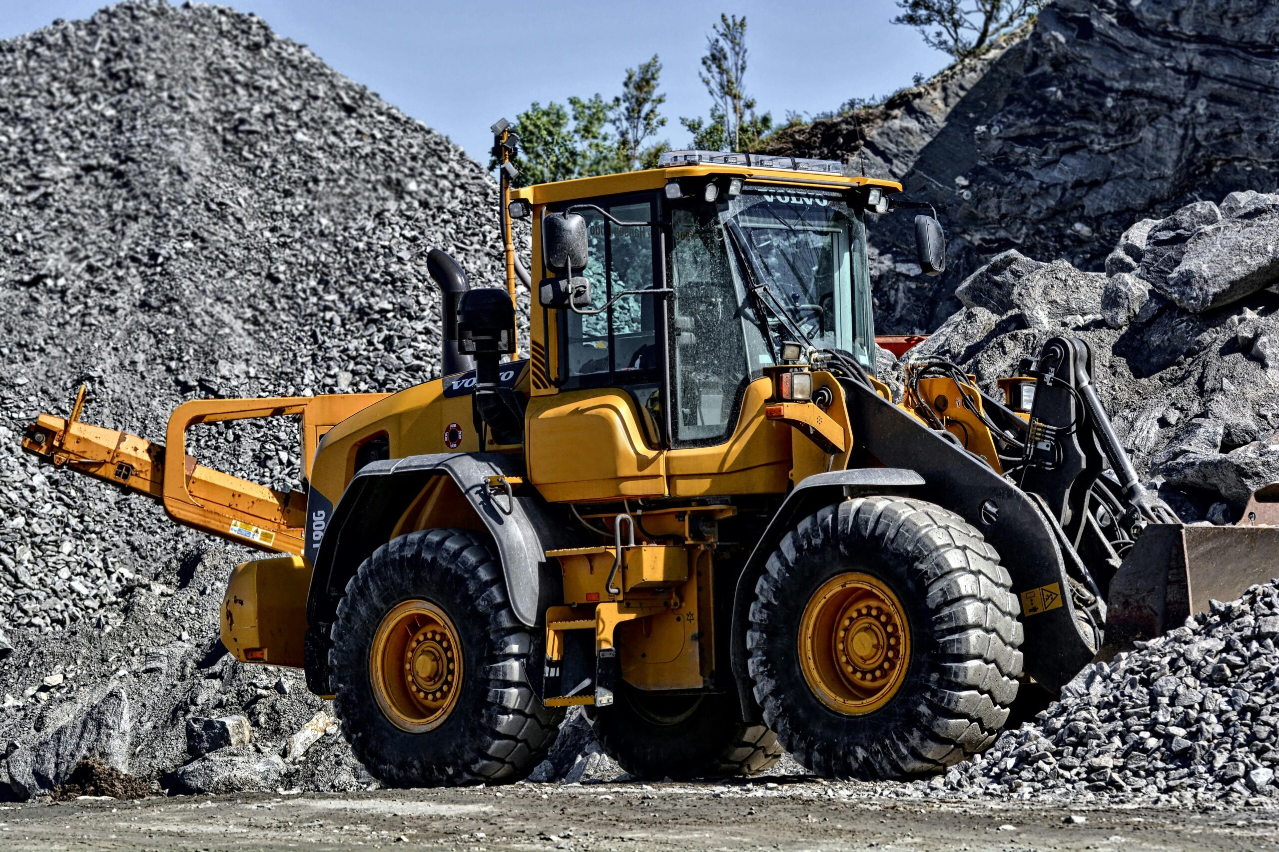 A construction vehicle on rocks and gravel moving materials.