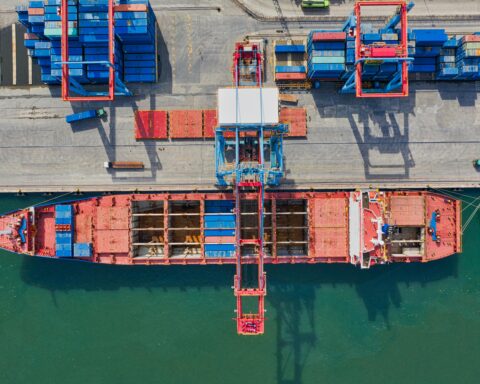 A container ship at port from an aerial perspective.