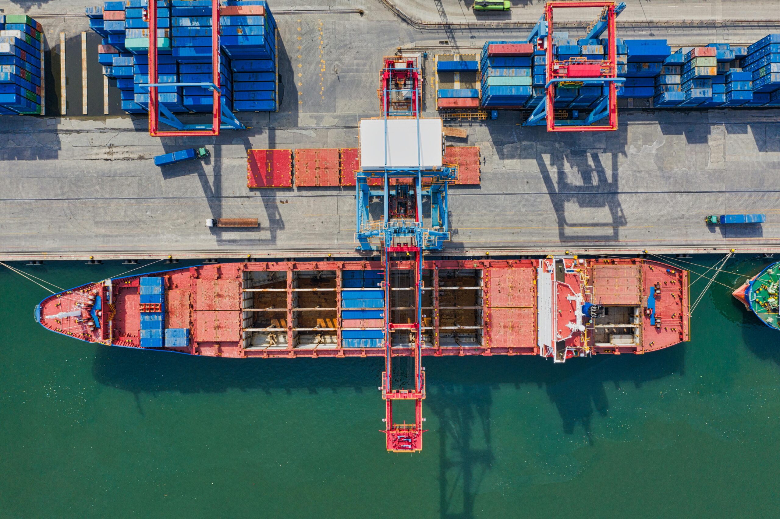 A container ship at port from an aerial perspective.