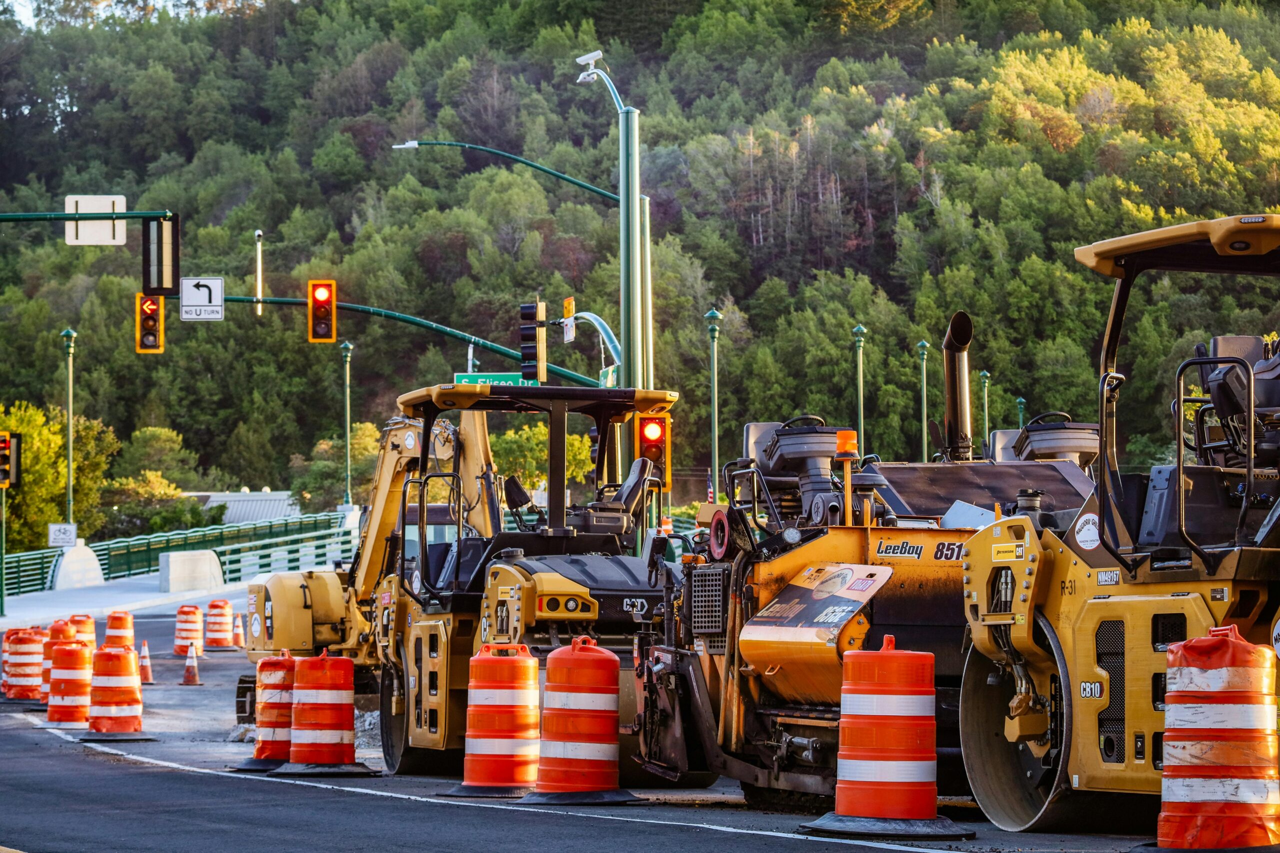 Construction vehicles line a road before construction.