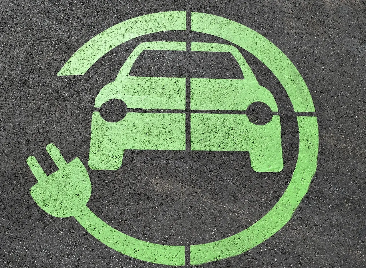 A symbol symbolizing a charging station for electric vehicles on asphalt.
