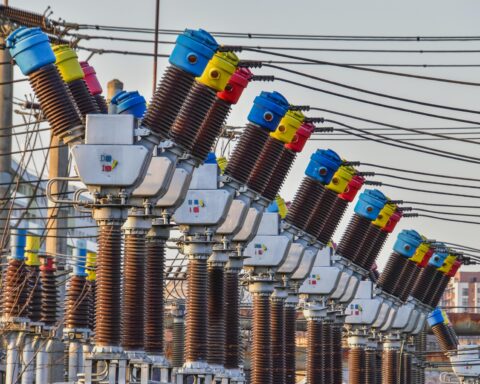 Transmission towers for energy in a row at a transmission station.