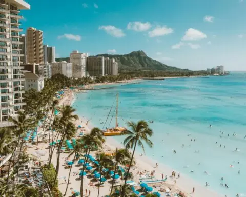 The beach of Honolulu, Hawai'i, from the balcony of a resort.