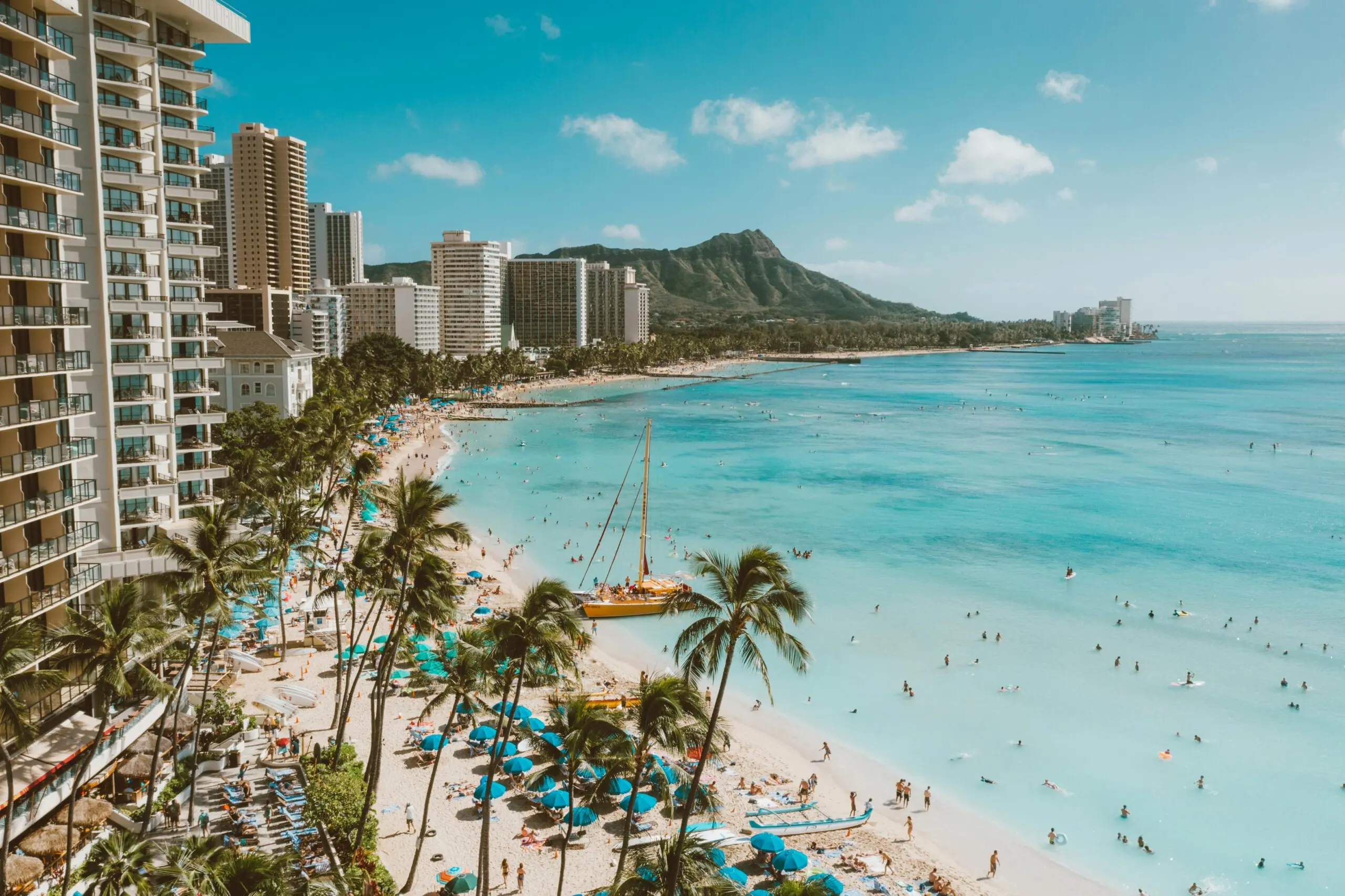 The beach of Honolulu, Hawai'i, from the balcony of a resort.