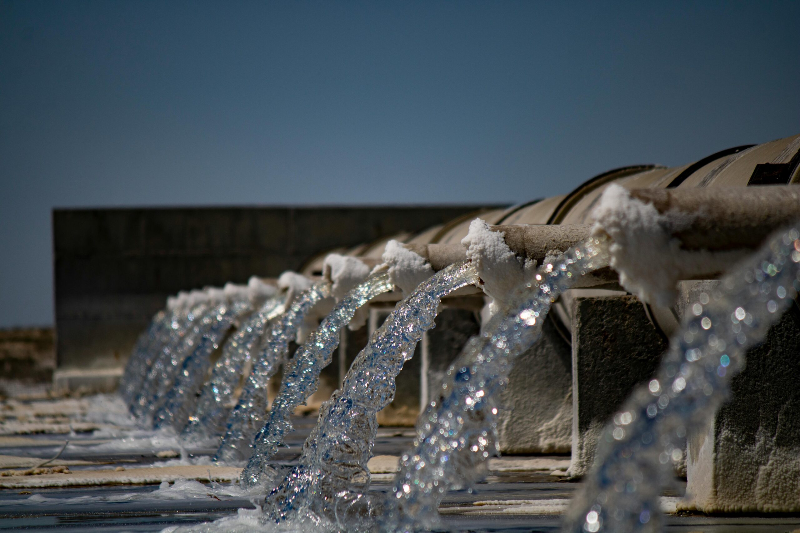 A series of pipes pour water into platforms below.