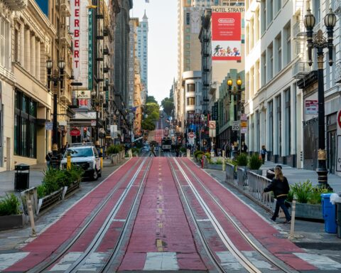 A blocked off street in San Francisco with space for buses, commercial vehicles, trolleys and safety pedestrian access.