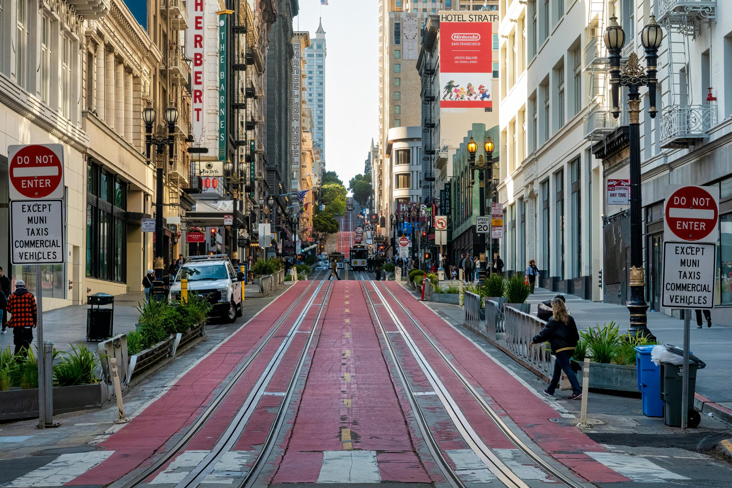 A blocked off street in San Francisco with space for buses, commercial vehicles, trolleys and safety pedestrian access.