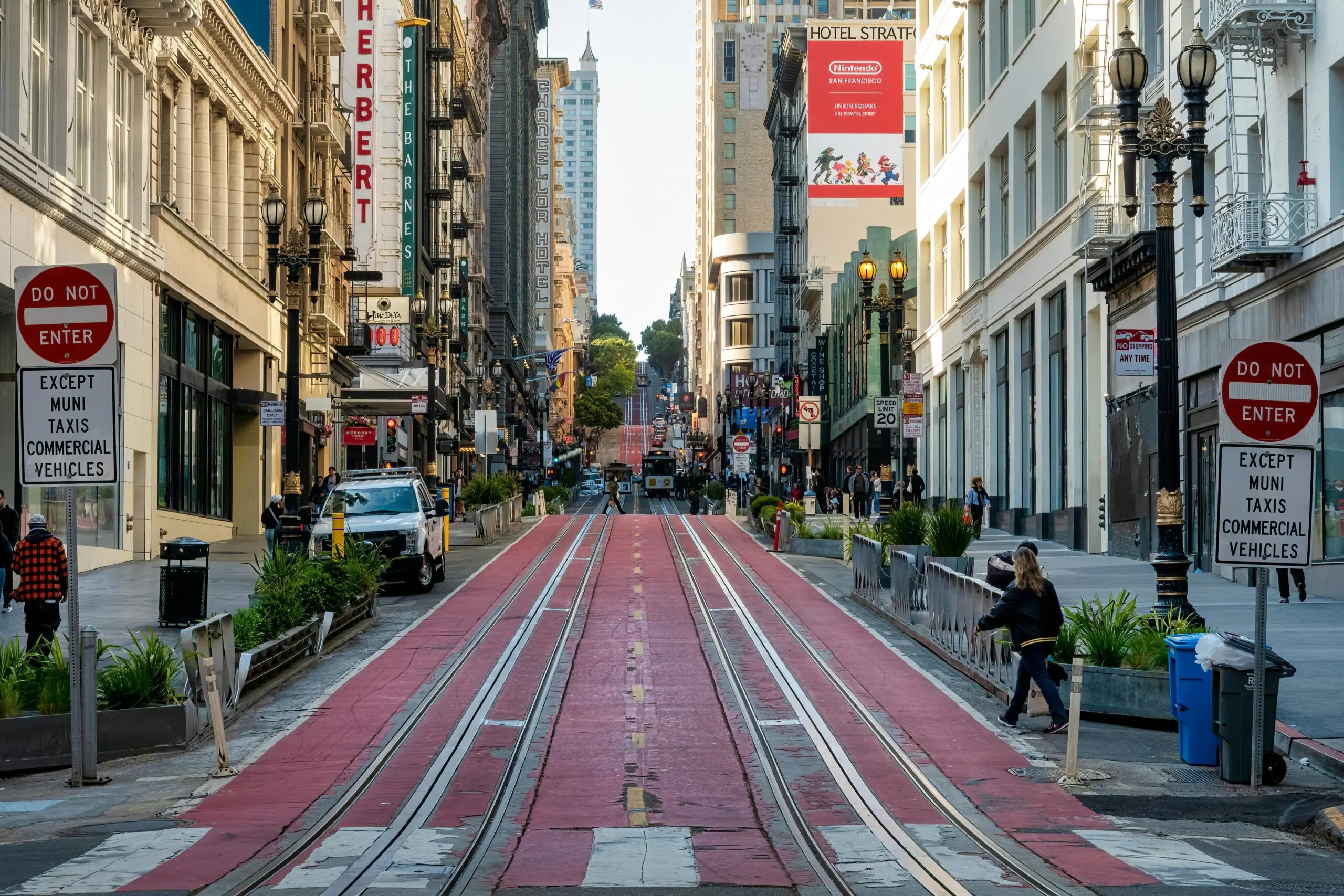 A blocked off street in San Francisco with space for buses, commercial vehicles, trolleys and safety pedestrian access.