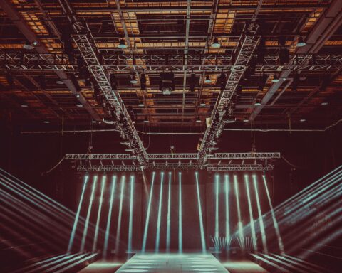 Lights illuminate a stage in a theater.
