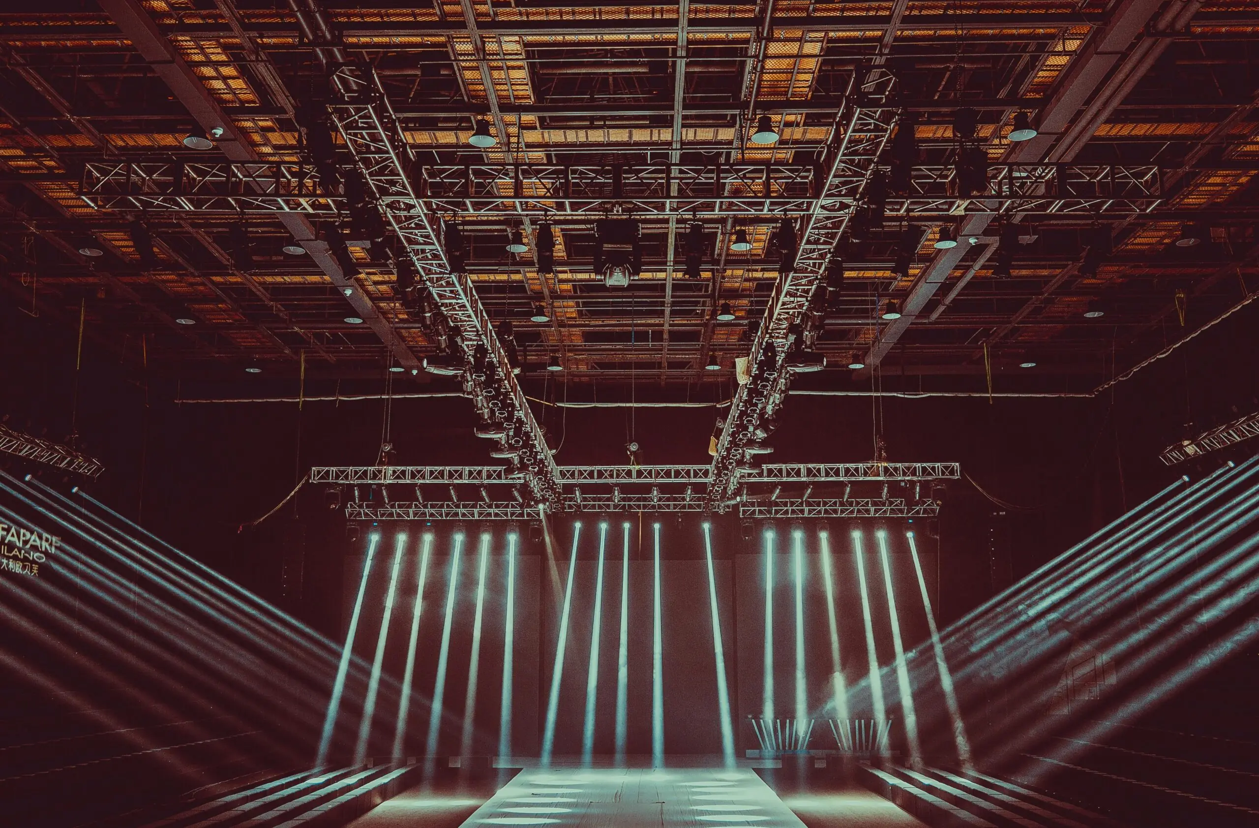 Lights illuminate a stage in a theater.