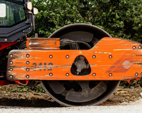 A construction roller prepares for repaving on a street or road.
