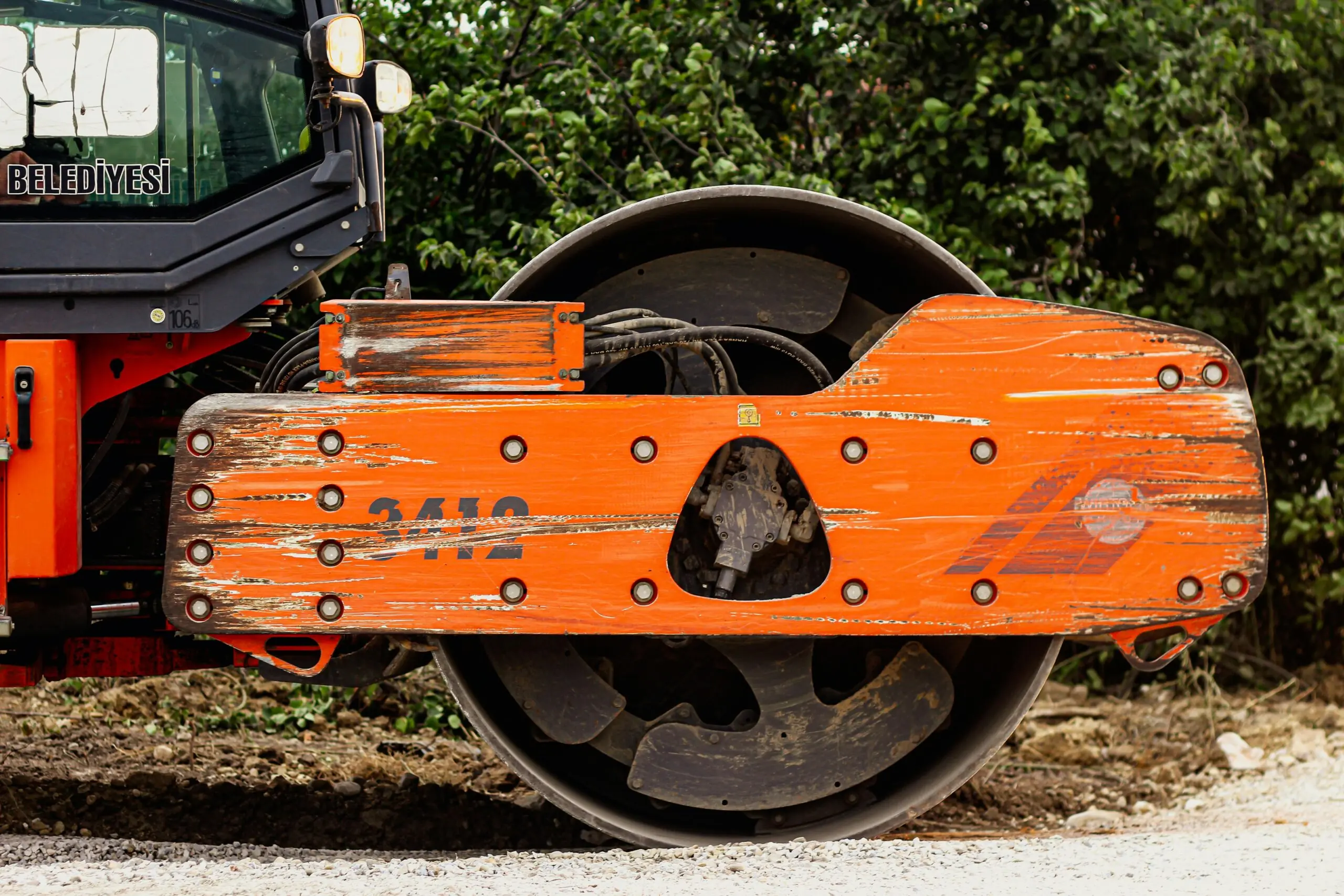 A construction roller prepares for repaving on a street or road.