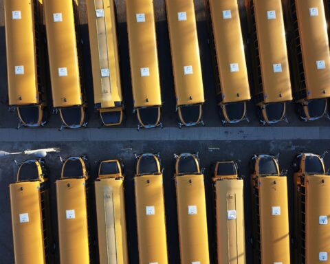 A fleet of school buses from an aerial view.