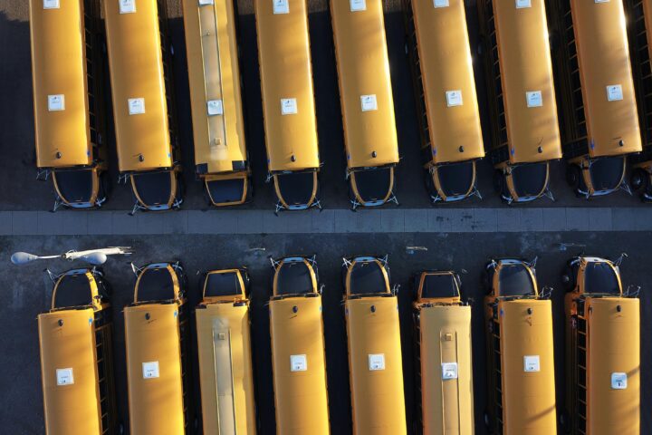 A fleet of school buses from an aerial view.