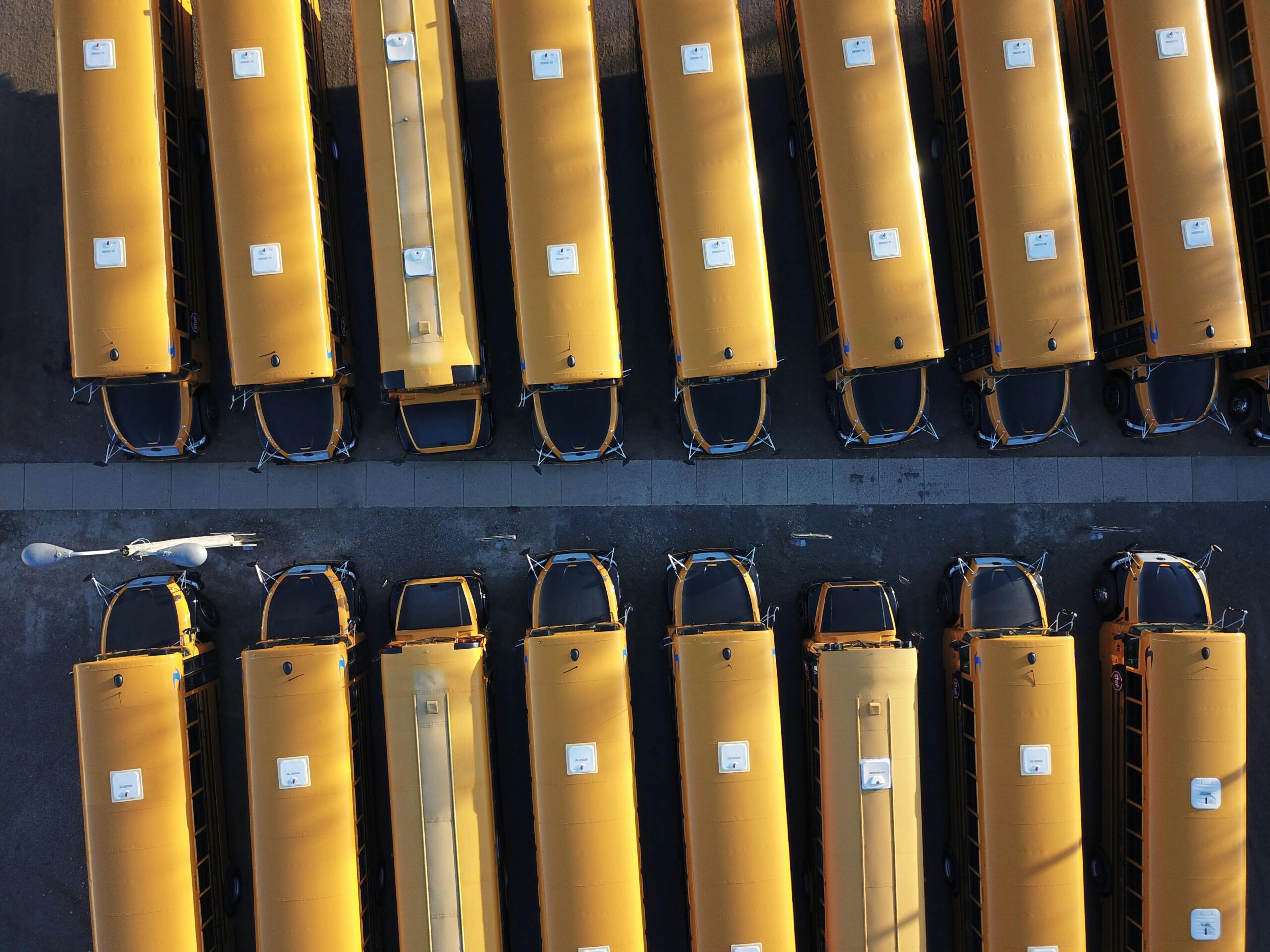 A fleet of school buses from an aerial view.