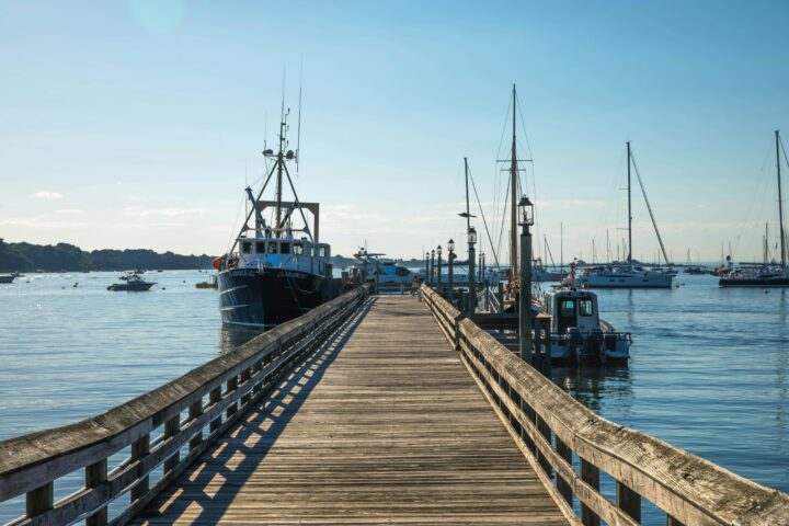 A wooden dock with connected ships at Port Jefferson on Long Island in New York.