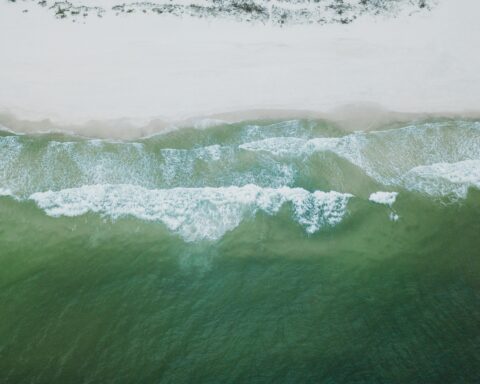 Waves roll on shore at a beach in Alabama.