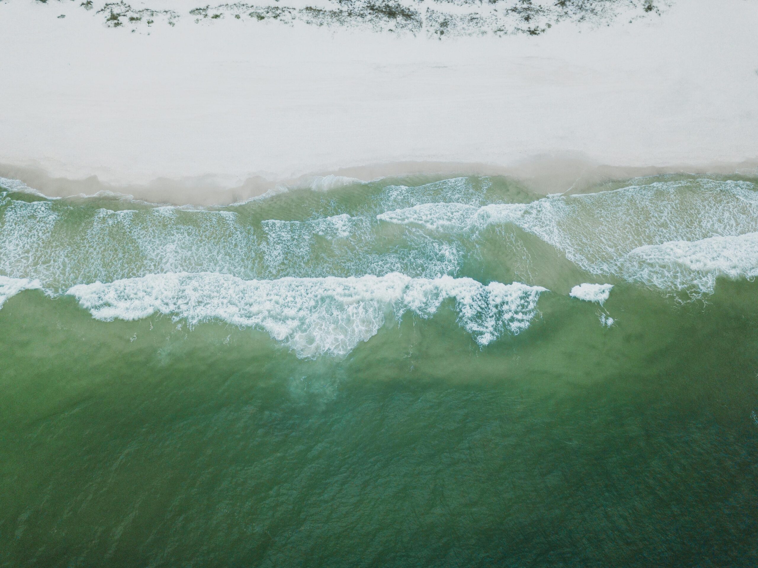Waves roll on shore at a beach in Alabama.