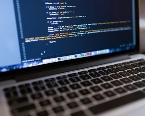 A computer with code on the screen indicating website design.