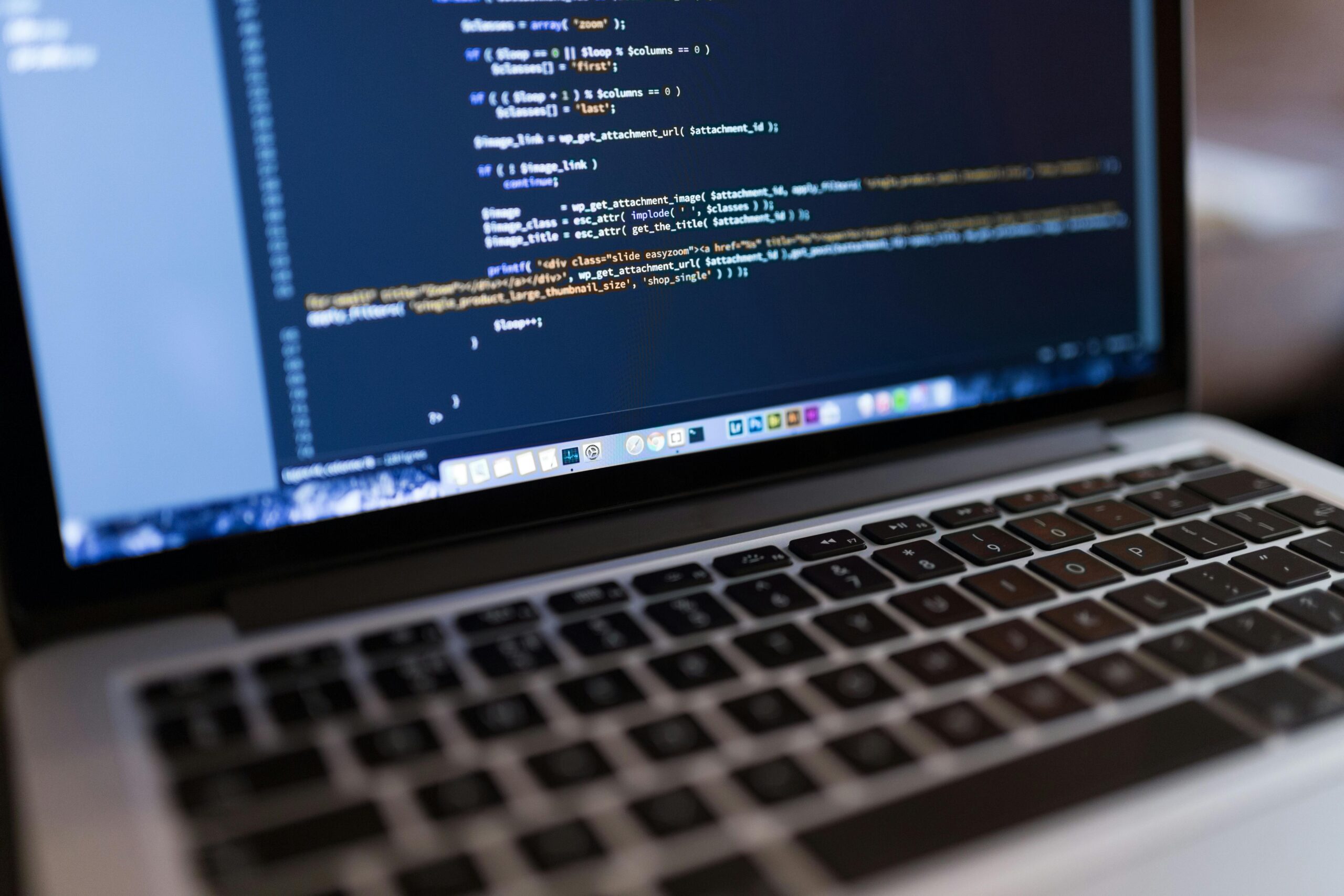 A computer with code on the screen indicating website design.