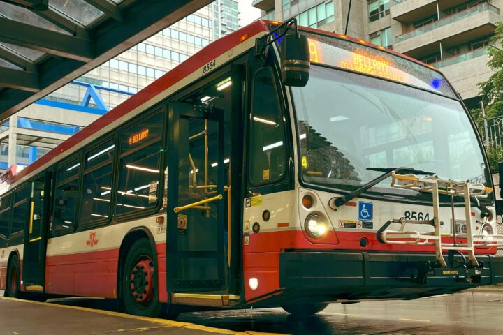 A bus sits at a station.