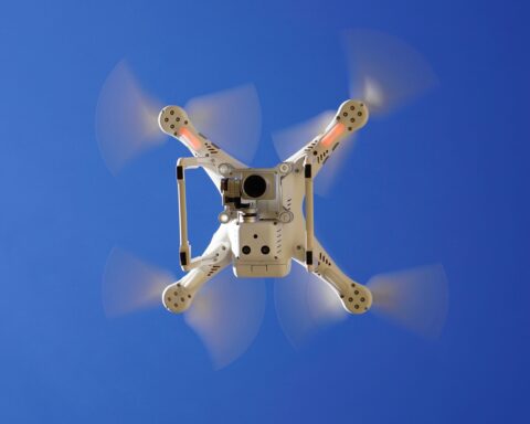 The underside of a flying drone with a camera.