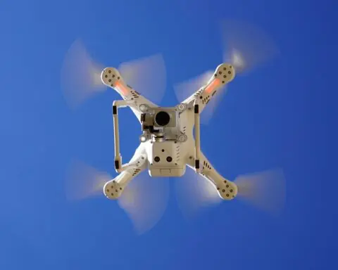 The underside of a flying drone with a camera.