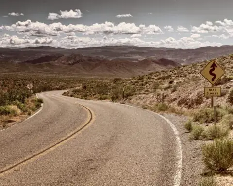 A stretch of Route 66 in California continuing through desert.