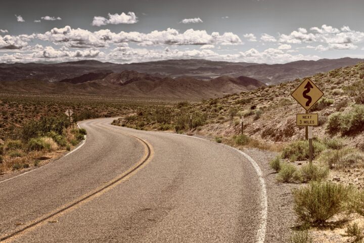 A stretch of Route 66 in California continuing through desert.
