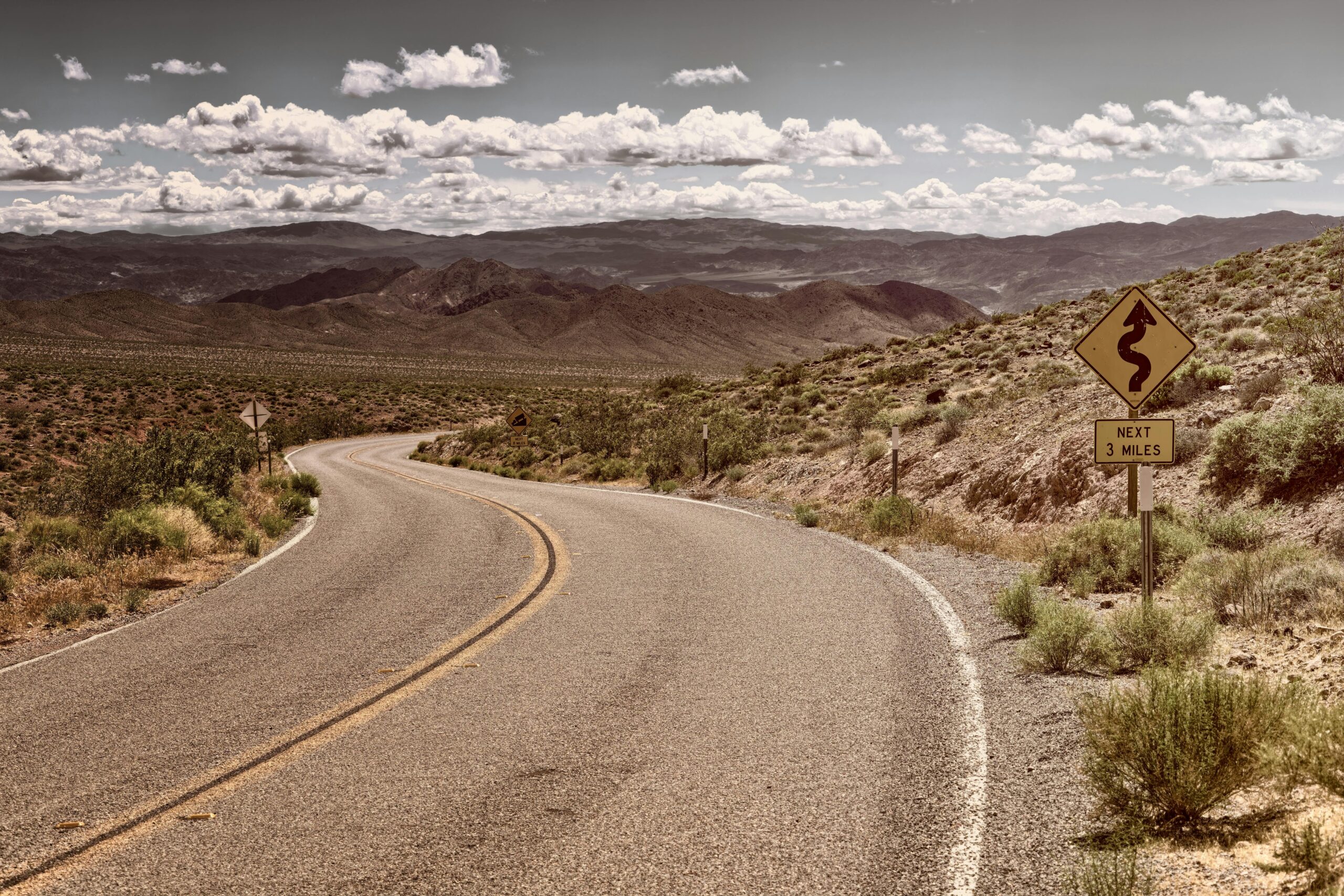 A stretch of Route 66 in California continuing through desert.
