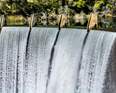 A reservoir pouring water down to a separate body in Auburn, California.
