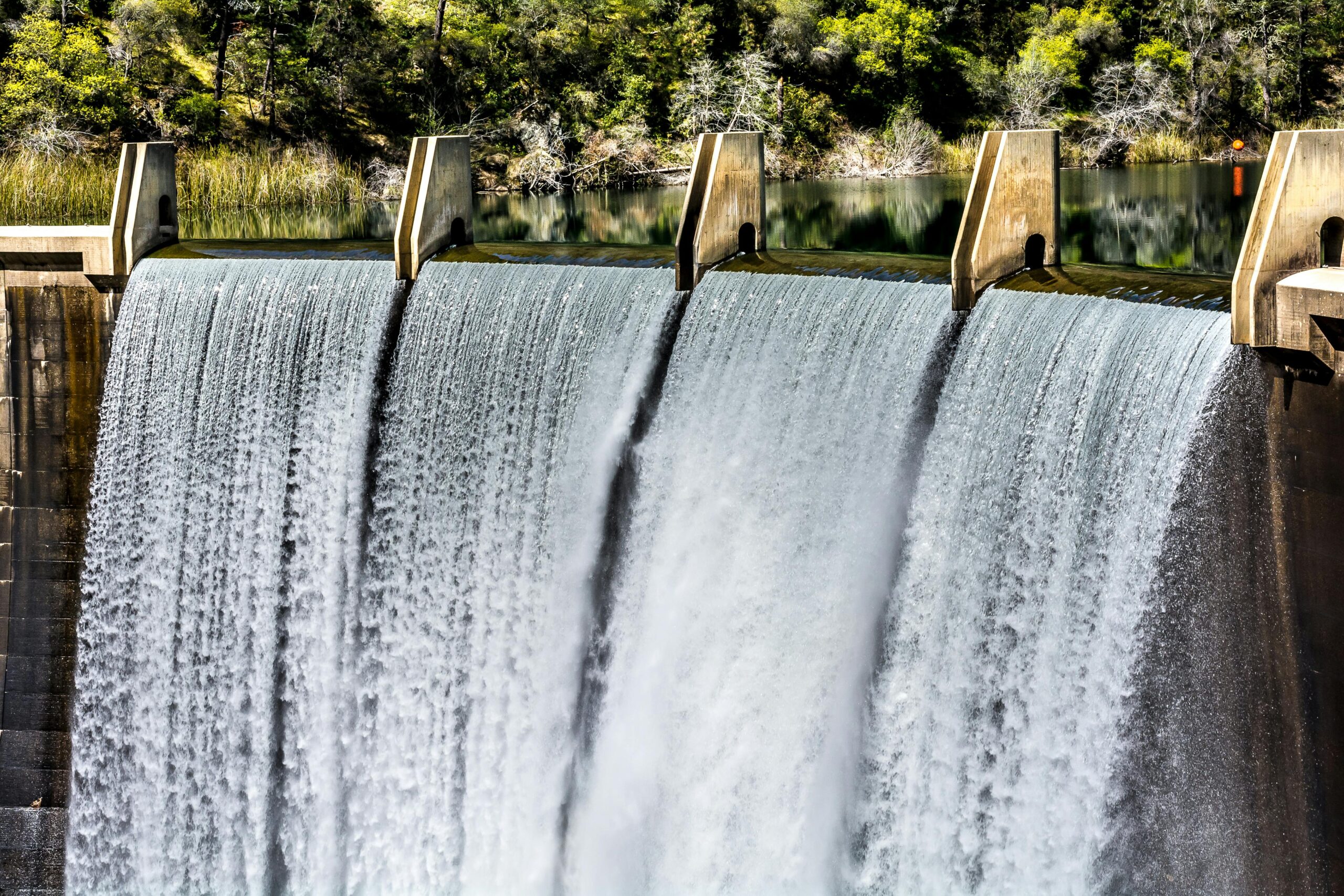 A reservoir pouring water down to a separate body in Auburn, California.