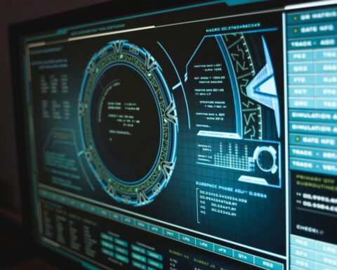 A computer screen shows blue text and digital images to depict hacking or cybersecurity software.