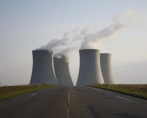 Four silos at nuclear reactor facility from a distance.