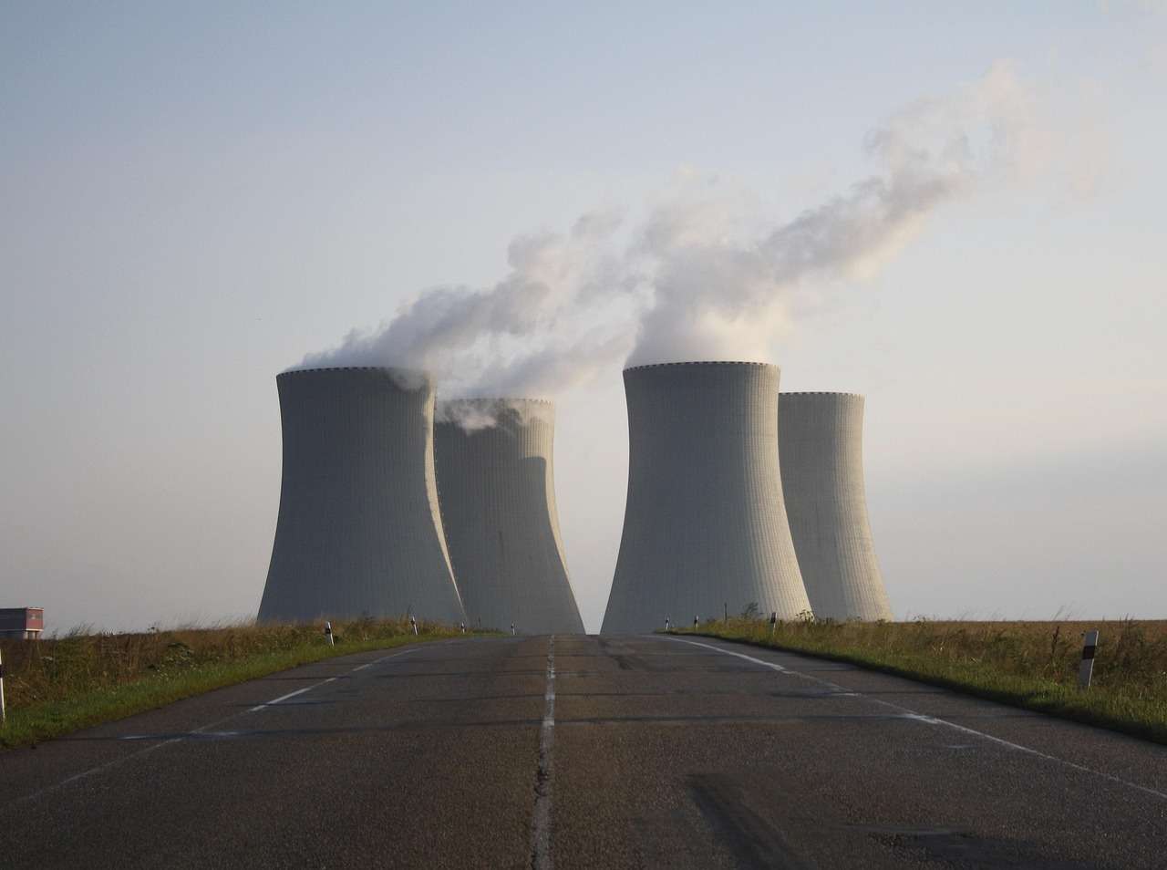 Four silos at nuclear reactor facility from a distance.