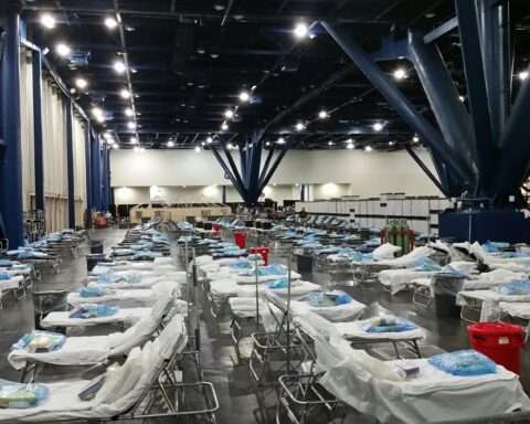 Dozens of hospital beds in a federal hospital facility.
