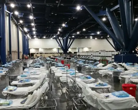 Dozens of hospital beds in a federal hospital facility.